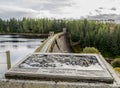 An information tile and Laggan Dam structure at Loch Laggan and River Spean in Scotland