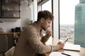 Businessman sit by window at kitchen read message on phone Royalty Free Stock Photo