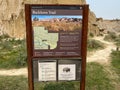 The informational sign at the Cannonballs area of the badlands hills and mountains in Theodore Roosevelt National Park Royalty Free Stock Photo