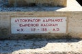 Informative inscription at the basis of the statue of the Roman Emperor Hadrian in Athens, Greece Royalty Free Stock Photo