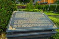 Informative sign on a black cement Stone statue of Vishnu in Gunung Kawi, Bali, Indonesia