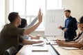 Diverse business partners holding hands asking questions to speaker Royalty Free Stock Photo