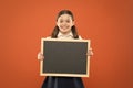 Informing kids changes in school life. School girl pupil hold blackboard copy space. School news concept. Check out