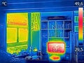 Infrared thermovision image showing heated TV and a window in th