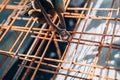 infrastructure - Construction worker hands securing steel bars with wire rod for cement reinforcement Royalty Free Stock Photo