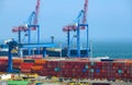 Infrastructure of an industrial seaport, container warehouse for loading onto a container ship, sea and cranes, the concept of sea