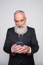 Infuriated senior man looking at smartphone Royalty Free Stock Photo