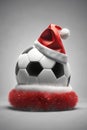 Santa hat on top of a soccer ball, christmas wallpaper, sports store banner Royalty Free Stock Photo