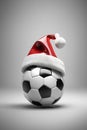 Santa hat on top of a soccer ball, christmas wallpaper, sports store banner Royalty Free Stock Photo