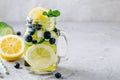 Infused detox water with lemon and cucumber slices, blueberry and mint. Ice cold summer lemonade in glass mason jar Royalty Free Stock Photo