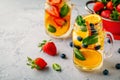 Infused detox water with orange, blueberry, strawberry and mint. Ice cold summer cocktail or lemonade. Royalty Free Stock Photo