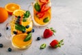 Infused detox water with orange, blueberry, strawberry and mint. Ice cold summer cocktail or lemonade. Royalty Free Stock Photo