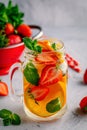 Infused detox water with orange, strawberry and mint. Ice cold summer cocktail or lemonade. Royalty Free Stock Photo