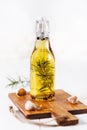 Infused olive oil over white wooden background