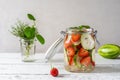 Infused water in glass jar made with strawberry and meloncella that is hybrid of cucumber and melon, thyme, mint. Royalty Free Stock Photo