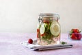 Infused water with strawberry and meloncella that is hybrid of cucumber and melon, thyme, mint. Copy space. Royalty Free Stock Photo