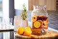 infused water jug with winter fruits on spa reception desk Royalty Free Stock Photo