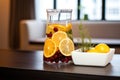 infused water jug with winter fruits on spa reception desk Royalty Free Stock Photo