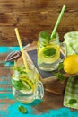 Infused water with lemon, cucumber and mint leaves over wooden background. Detox and healthy lifestyle concept Royalty Free Stock Photo