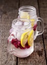 Infused Water with Lemon and Raspberry Healthy Detox Drink Cold Berry Fruit Lemonad in Glass Jars Wooden Background Vertical Royalty Free Stock Photo