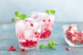 Infused water made of fresh pomegranate and mineral water with ice