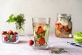 Infused water with strawberry and meloncella that is hybrid of cucumber and melon, thyme, mint. Royalty Free Stock Photo