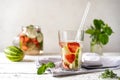 Infused water with strawberry and meloncella that is hybrid of cucumber and melon, thyme, mint. Royalty Free Stock Photo