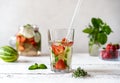 Infused water with strawberry and meloncella that is hybrid of cucumber and melon, thyme, mint. Royalty Free Stock Photo