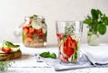 Infused water with strawberry and meloncella that is hybrid of cucumber and melon, thyme, mint. Royalty Free Stock Photo