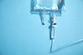 Infusion bag in the blue background. IV drip chamber Royalty Free Stock Photo