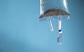 Infusion bag in the blue background. IV drip chamber Royalty Free Stock Photo