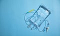 Infusion bag in the blue background. IV drip chamber Royalty Free Stock Photo