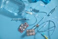 Infusion bag, syringe, medical ampoules in the blue background. IV drip chamber Royalty Free Stock Photo