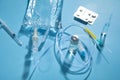 Infusion bag, syringe, medical ampoules in the blue background. IV drip chamber Royalty Free Stock Photo