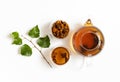 Infusion with chaga mushroom isolated on a white background. Beverage with pieces of birch mushroom in a transparent bowl. View