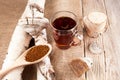 Infusion of chaga mushrooms in a glass cup on a wooden background with burlap in a rustic style. Healthy beverage. View from above