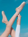 Touching the sky. Pointe shoes worn by ballet dancer. Ballet slippers. Ballerina shoes. Ballerina legs in ballet shoes Royalty Free Stock Photo