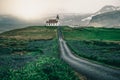 Ingjaldsholl church in Iceland and lupine flowers