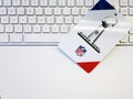 white badge with the 2022 NFL Super Bowl logo on a computer keyboard Royalty Free Stock Photo