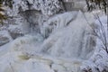 Inglis Falls flowing during Winter surrounded by huge icicles