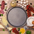 Ingredients around a pan ready to make a fresh homemade pizza Royalty Free Stock Photo