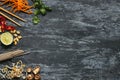 Ingredients for asian dish. Dried asian soba noodles with different ingredients on wooden background with copy space.