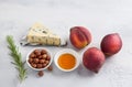 Ingredients for baked peaches: fresh peaches, blue cheese, hazelnuts, honey and rosemary on a light gray background Royalty Free Stock Photo