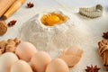 Ingredients for baking cake and accessories on the gray table: rolling pin, eggs, ginger, anise stars, cinnamon and bakewares