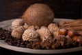 Ingredients for baking, cinnamon sticks, star anise, cloves, nuts, coconut, coffee beans on a wooden background Royalty Free Stock Photo