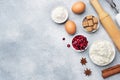 Ingredients for baking cookies, cupcakes and cake. Raw foods eggs flour sugar cottage cheese cranberries on a grey background with