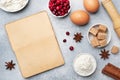Ingredients for baking cookies, cupcakes and cake. Raw foods eggs flour sugar cottage cheese cranberries on a grey background with