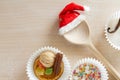 Ingredients for baking cookies and spoon in santa hat, christmas background concept Royalty Free Stock Photo