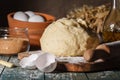 Ingredients for baking croissants - flour, wooden spoon, rolling pin, eggs, egg yolks, butter served on wooden background Royalty Free Stock Photo
