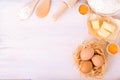 Ingredients for baking croissants - paper, flour, wooden spoon, rolling pin, eggs, egg yolks, butter served on white Royalty Free Stock Photo